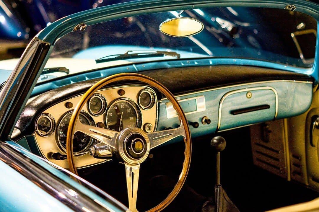 CLASSIC CAR INSURANCE- RISK COVERAGE INSURANCE ALT: Restored classic car interior with vintage dashboard and steering wheel